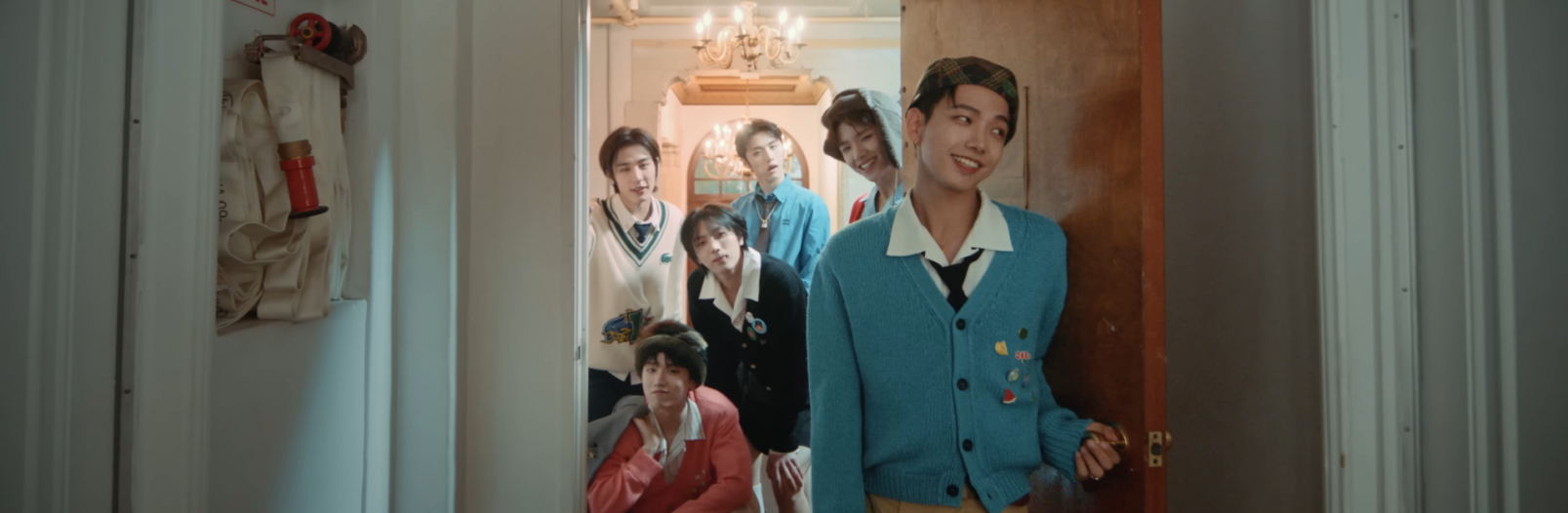 Image shows the 6 members of BOYNEXTDOOR in a doorway smiling at the camera