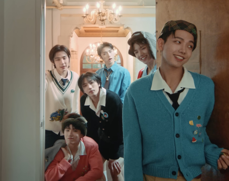 Image shows the 6 members of BOYNEXTDOOR in a doorway smiling at the camera