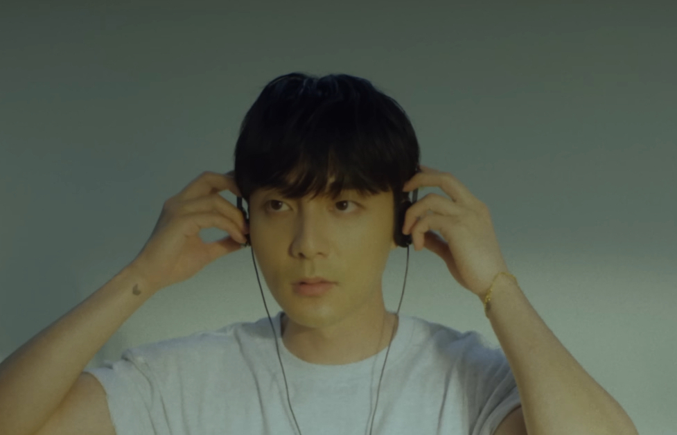 Image shows Roy Kim putting on headphones as he looks off camera