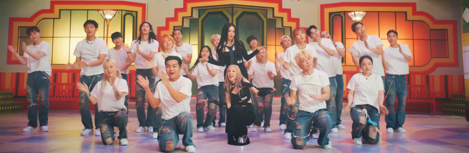 Uhm Jung Hwa and Sandara Park are posing in the middle with arms out, while surrounded by clapping backup dancers