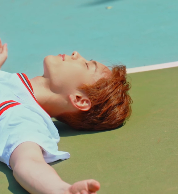 Yeong Seobin is laying down flat on his back on a basketball court. He is wearing a Chicago Bulls Jersey, and a basketball is laying next to him