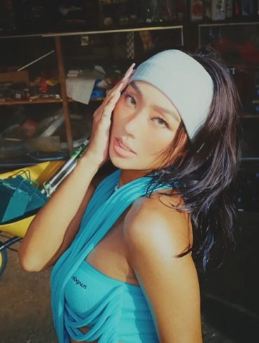 Hyolyn is in a shed filled with tools and an older man laying in a hammock.