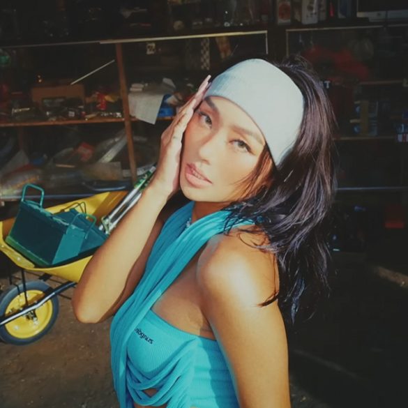 Hyolyn is in a shed filled with tools and an older man laying in a hammock.